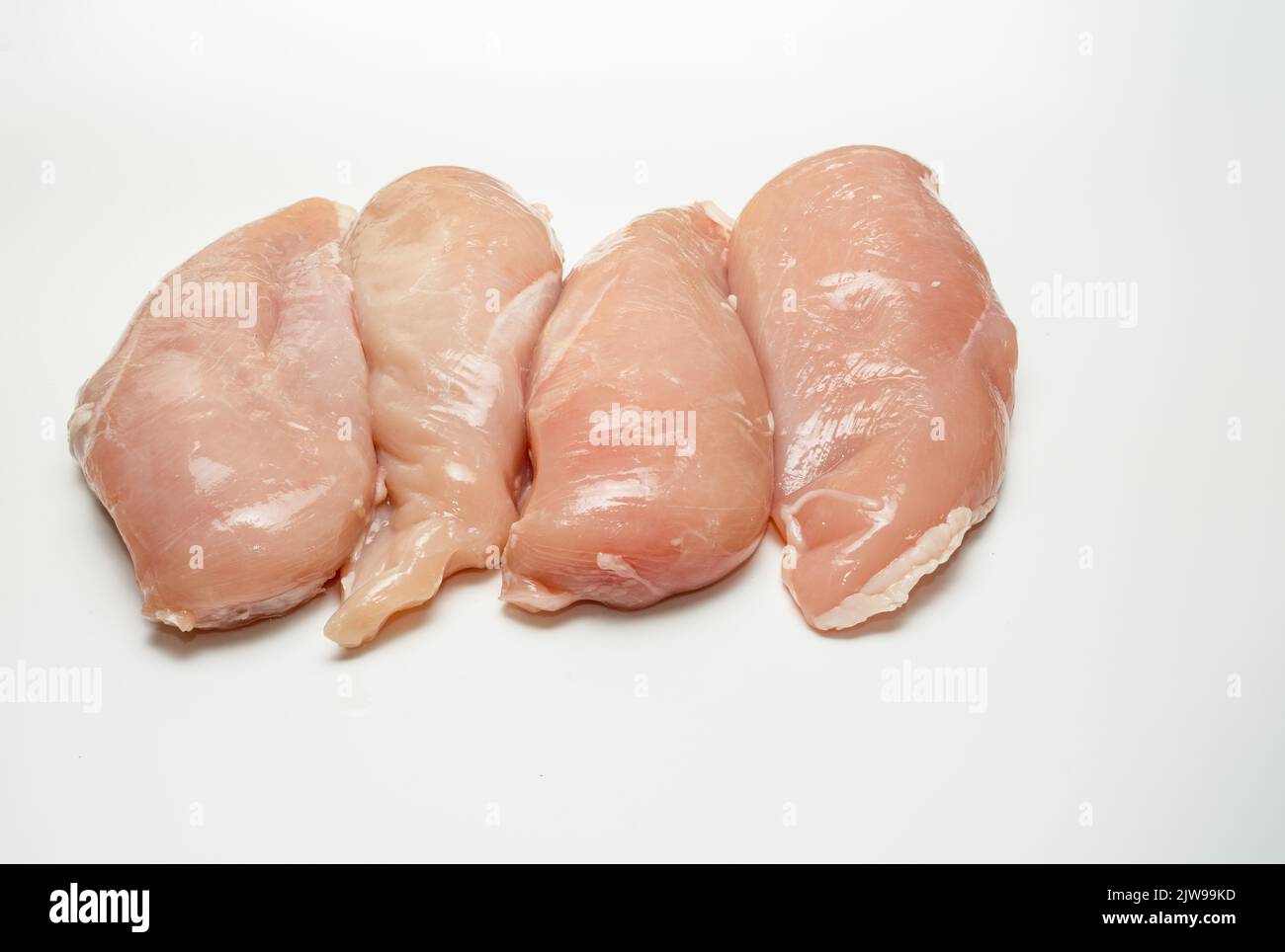 Raw uncooked prepared poultry chicken breasts on a white background Stock Photo