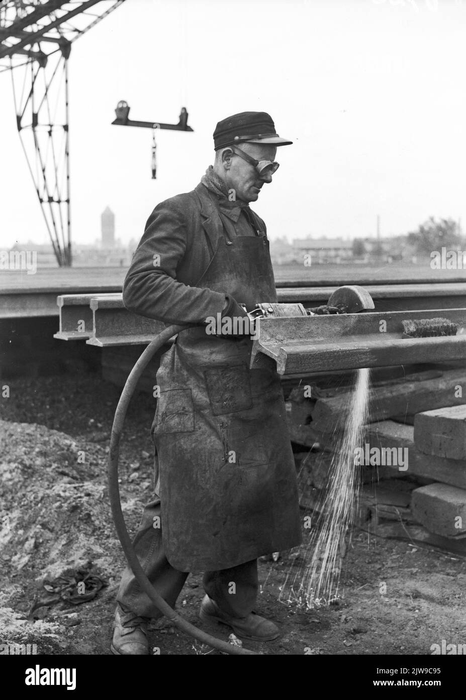 Image of an employee of the rail lashing (SLI) of the N.S. in Utrecht during the grinding of a piece of rail. Stock Photo