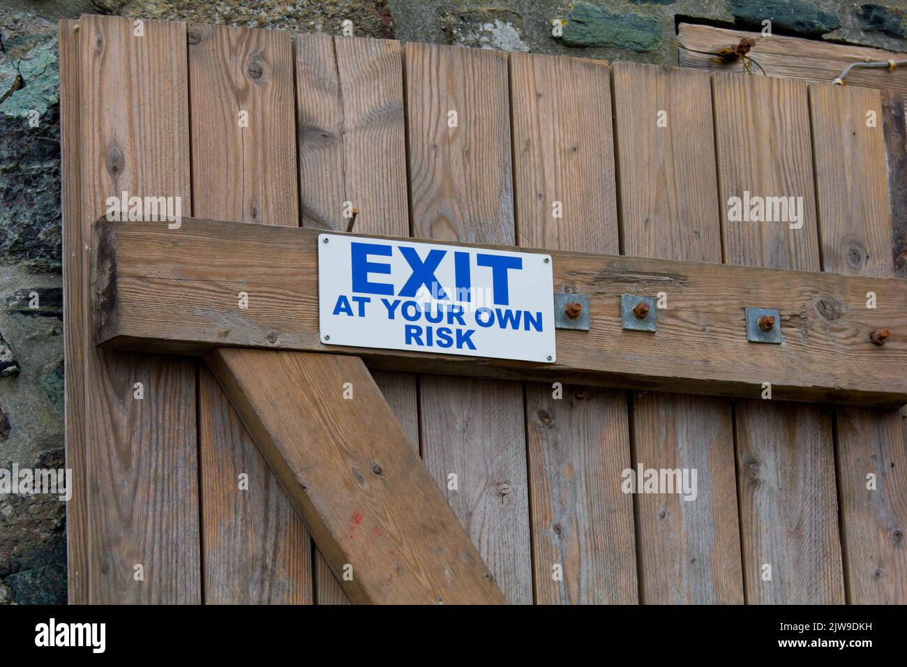 Exit sign warning of risk Stock Photo