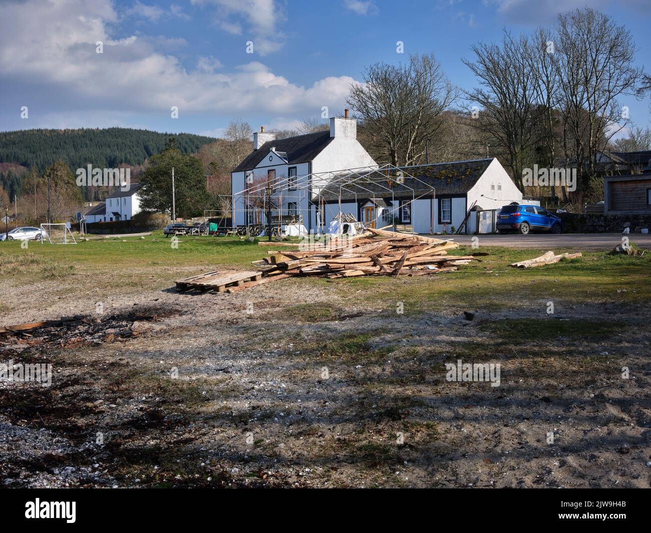 A pile of timber and a marquee frame covers the front view of the Otter