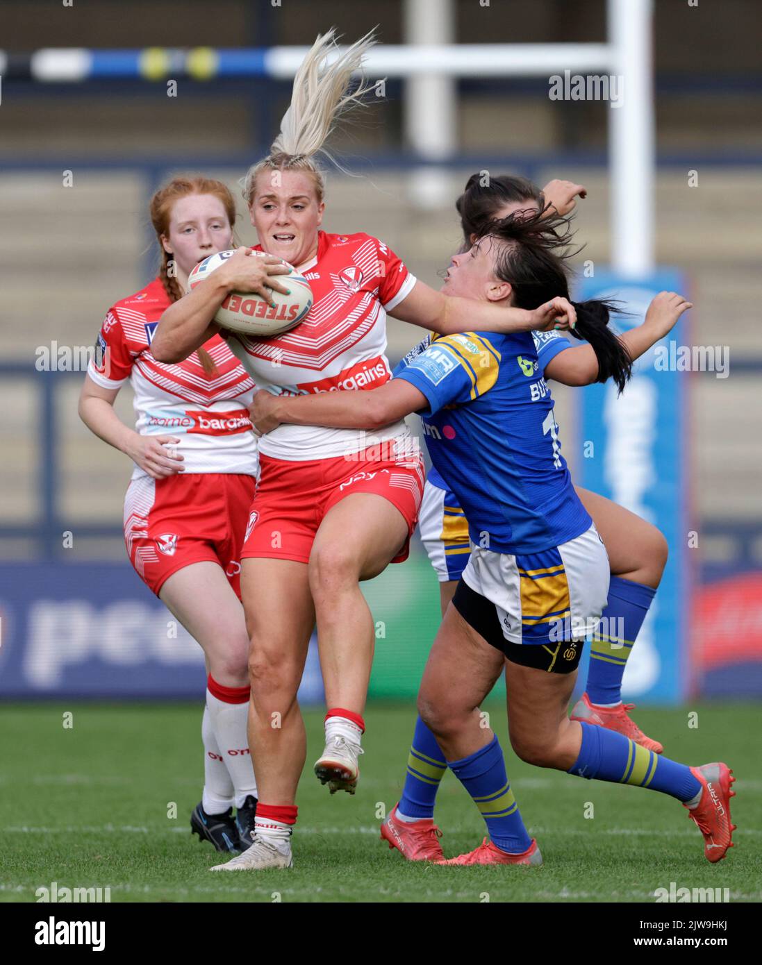 St Helen’s Amy Hardcastle is tackled by Leeds Rhinos Hanna Butcher during the Betfred Women's Super League Semi Final at Headingley Stadium, Leeds. Picture date: Sunday September 4, 2022. Stock Photo