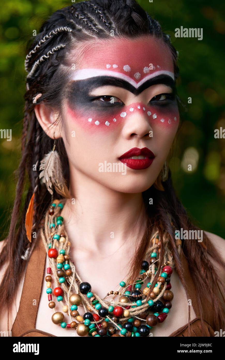Outdoor close-up portrait of the beautiful young shamaness (witch doctor) Stock Photo