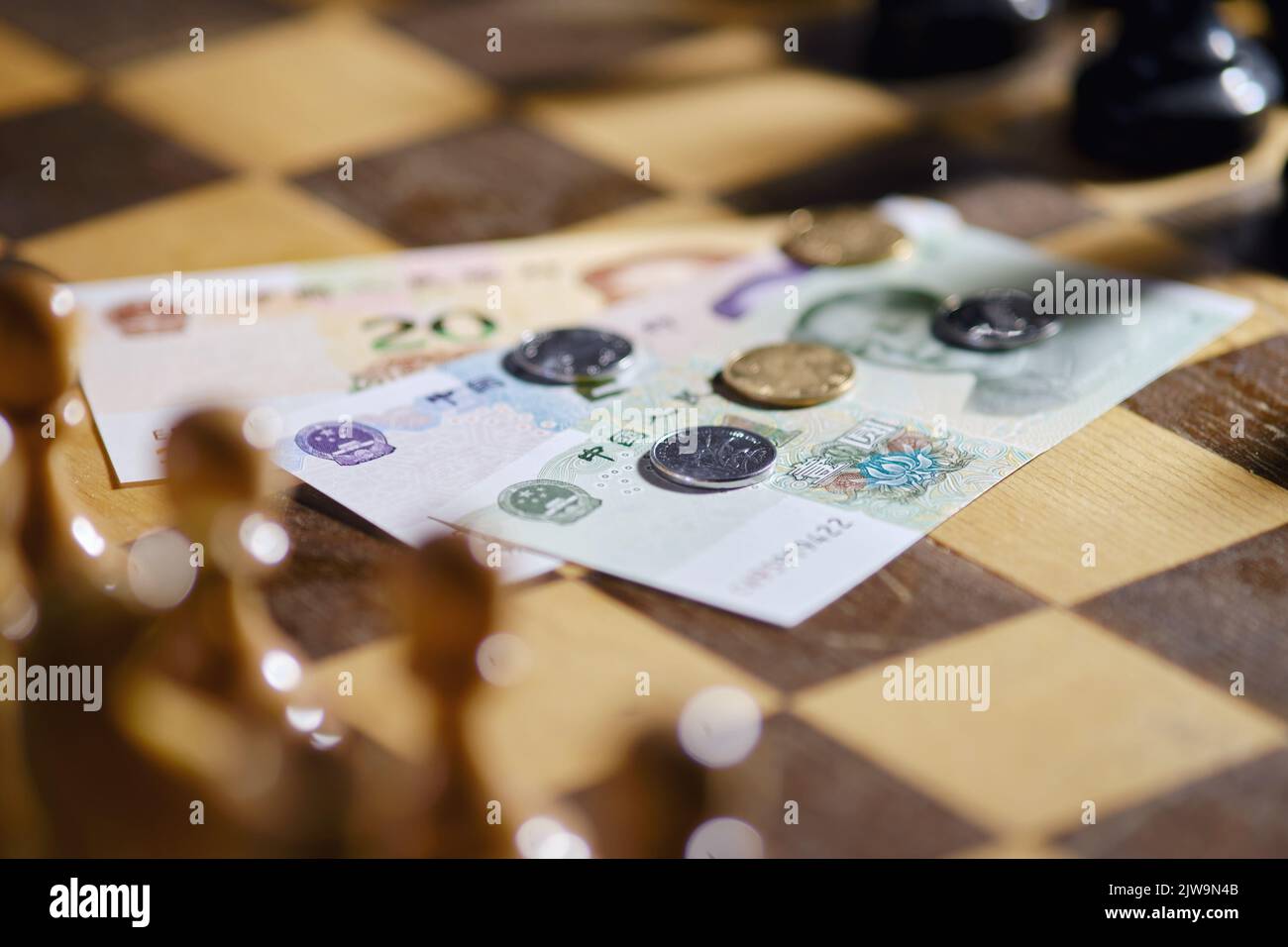 Chinese yuan money on the background of a chess board. Banknotes and ...