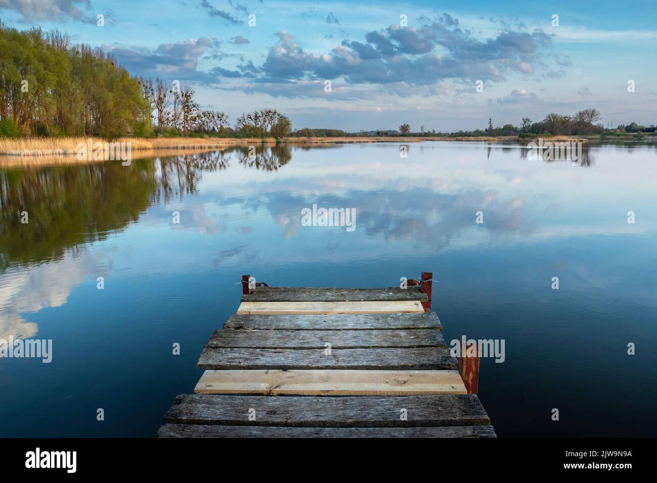 Wooden pier jutting out into the lake Stock Photo