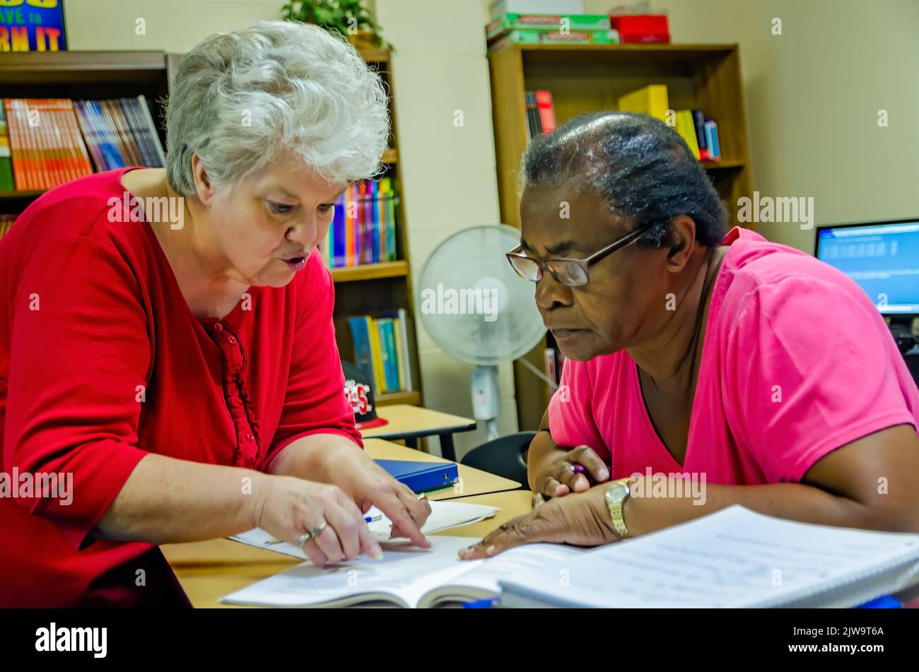 A GED Instructor tutors an elderly student at Greater Columbus Learning Center, June 27, 2012, in Columbus, Mississippi. The GED is a General Educatio Stock Photo