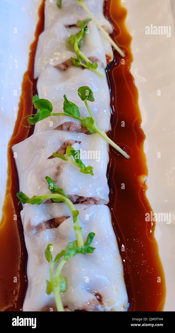 Chinese steamed rice noodle rolls with beef and soy sauce Stock Photo