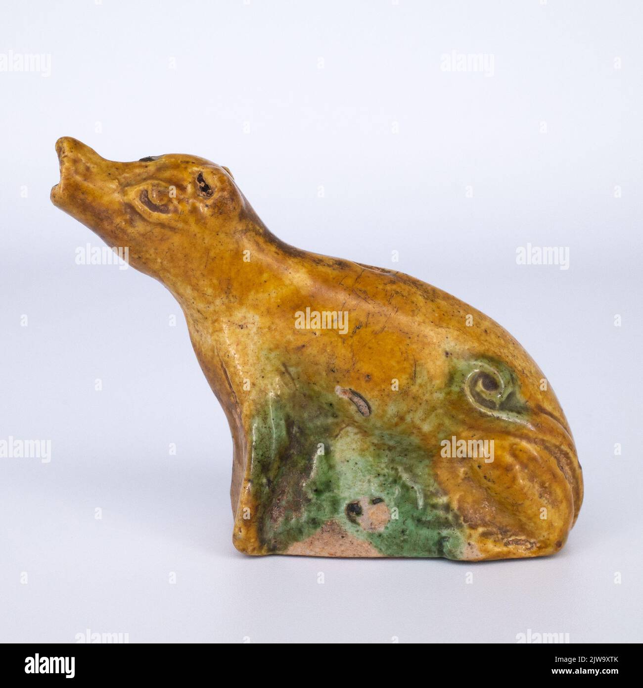 Antique Chinese Sancai Glazed Biscuit Model of a Howling Dog or Wolf Stock Photo