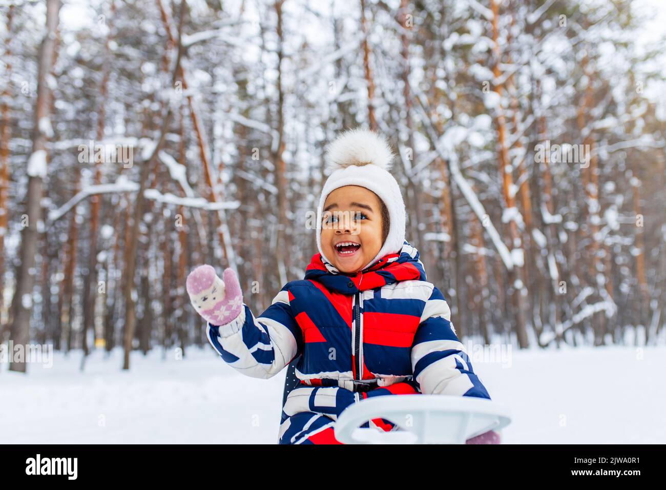 happy little girl enjoy a sleigh ride on christmas holidays Stock Photo
