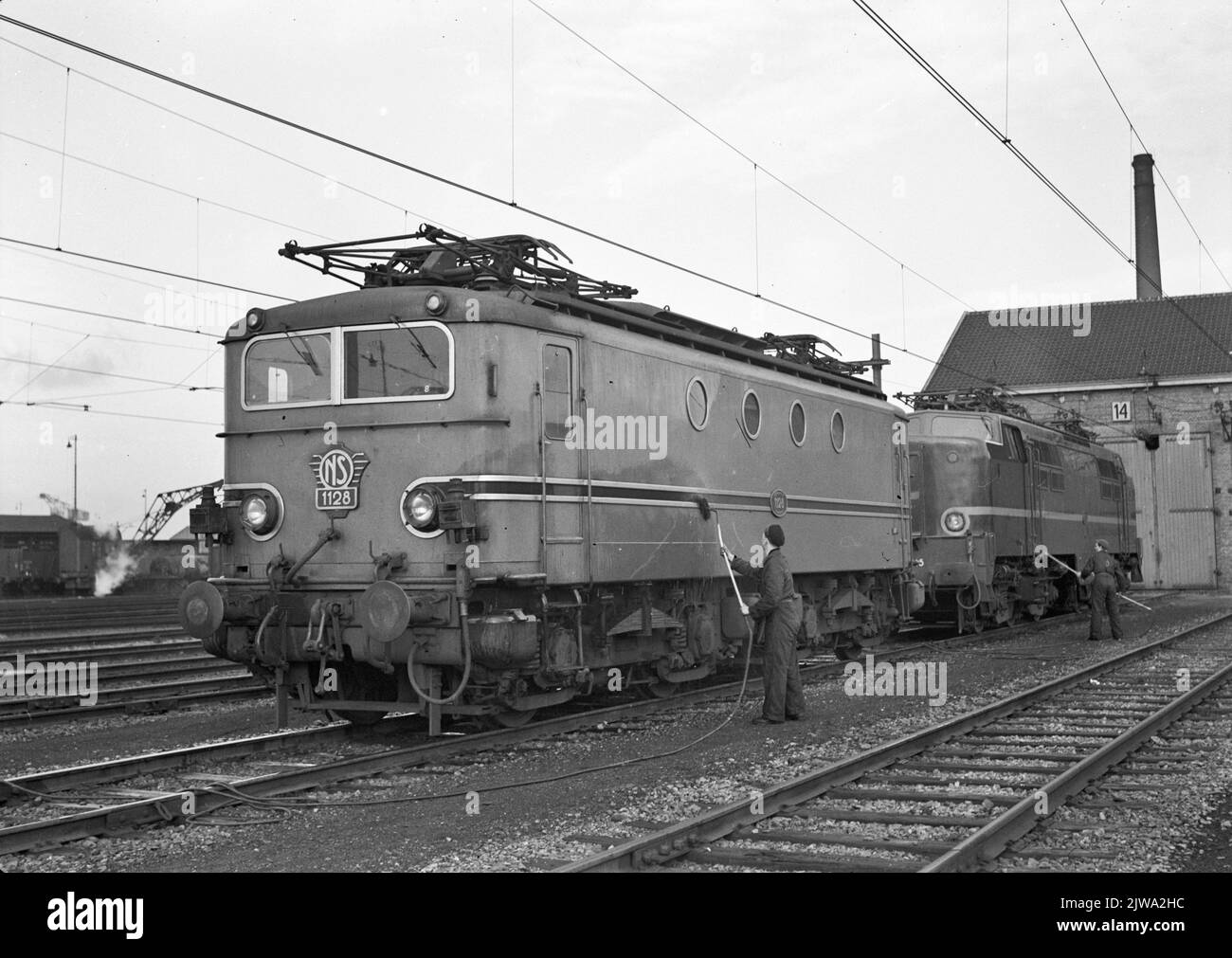 Image of the electric locomotive No. 1128 (series 1100) and an electric locomotive from the 1200 series during cleaning work on the yard in Maastricht. Stock Photo