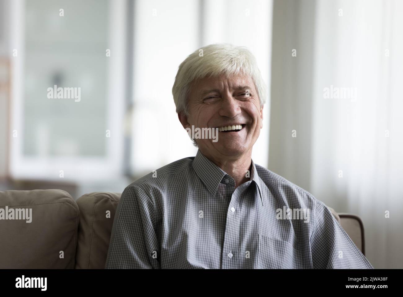 Happy senior man talking on video call from home Stock Photo