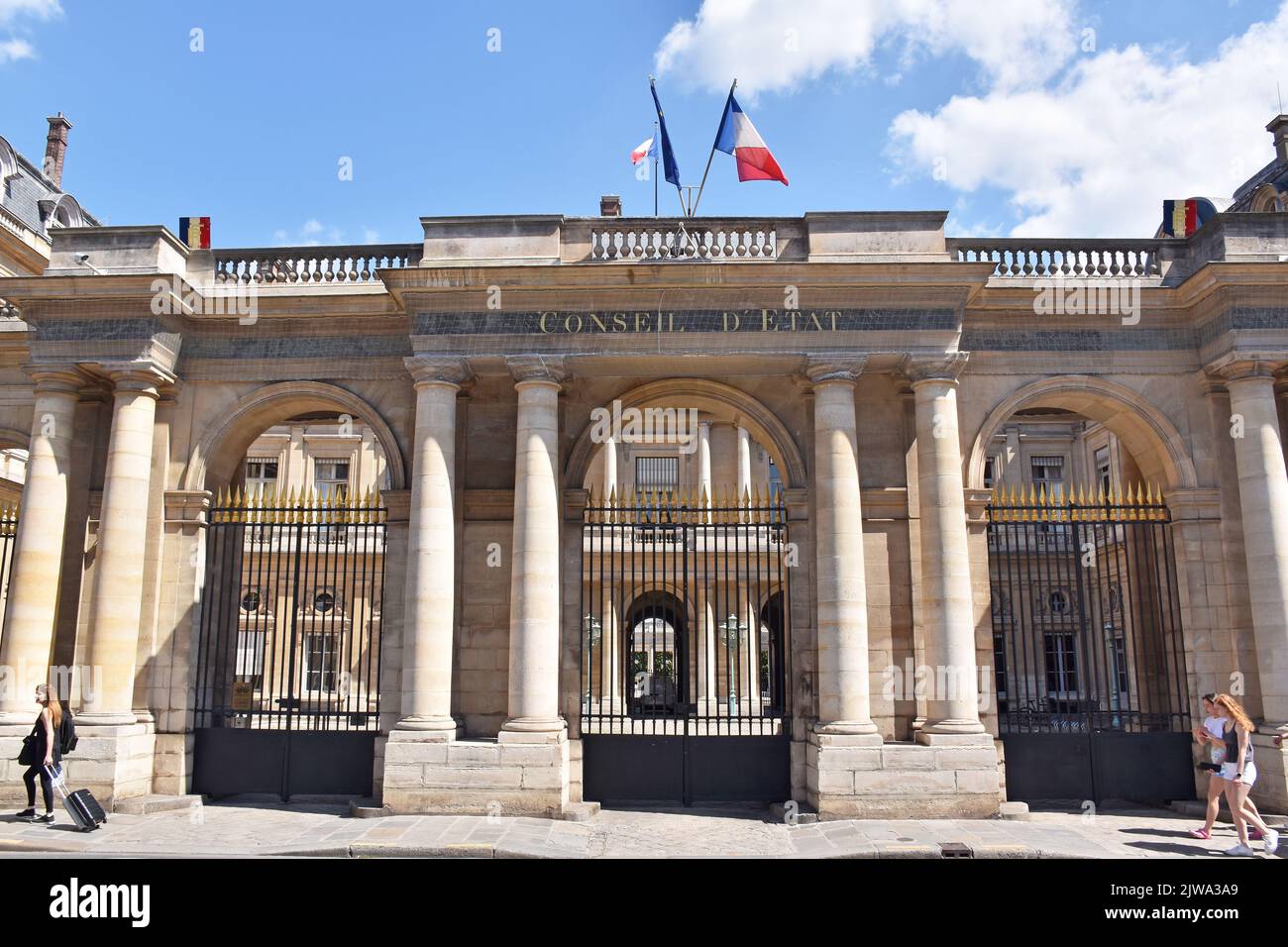 The screen of the southern entrance to the Palais Royale on r. St. Honoré, opening into the Cour de l’Horloge, & the building of the Conseil d'Etat Stock Photo