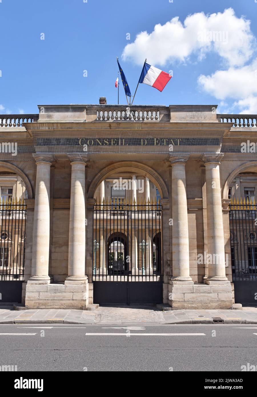 The screen of the southern entrance to the Palais Royale on r. St. Honoré, opening into the Cour de l’Horloge, & the building of the Conseil d'Etat Stock Photo