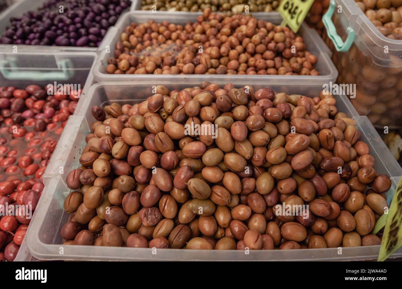 Selective focus on green olives at a Farmers Market. Olive varieties. Close up Stock Photo