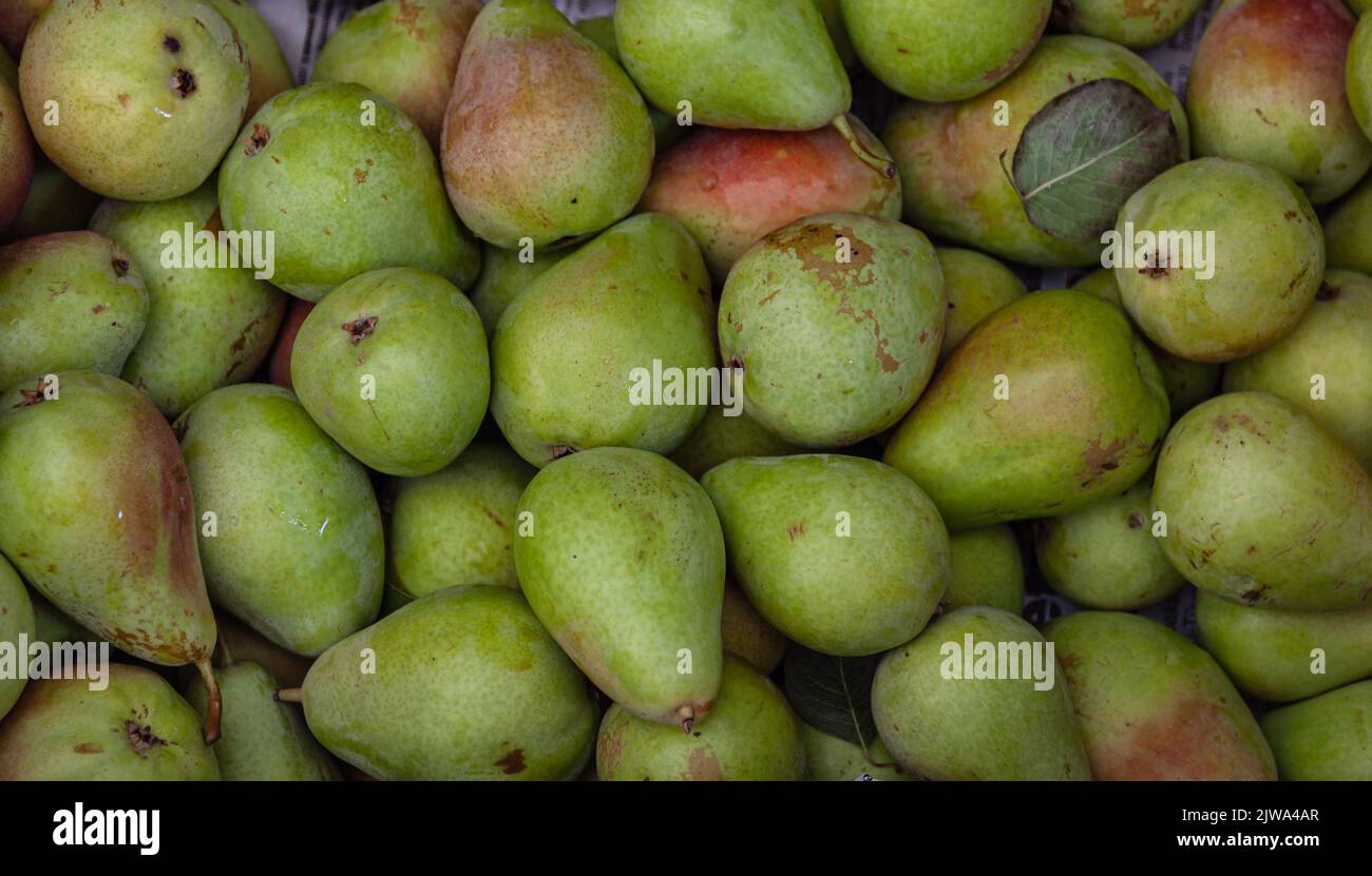 Pear pile. Selective focus on fresh pears at a Farmers Market. Top of view. Stock Photo