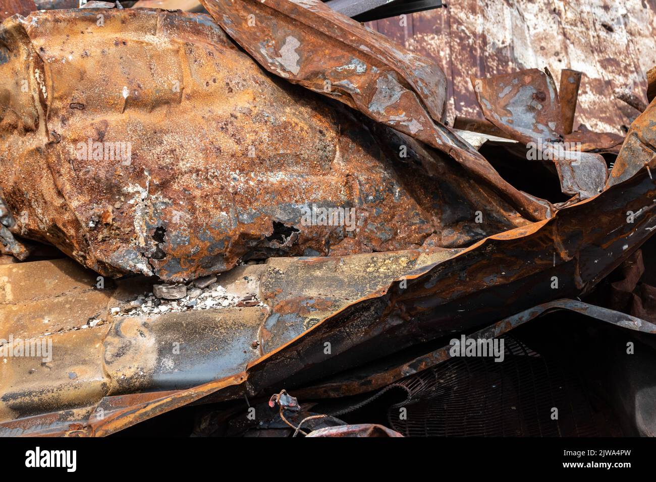 Rusty background. Remains of a burnt house. Rusty surface texture. Consequences of enemy shelling. Stock Photo