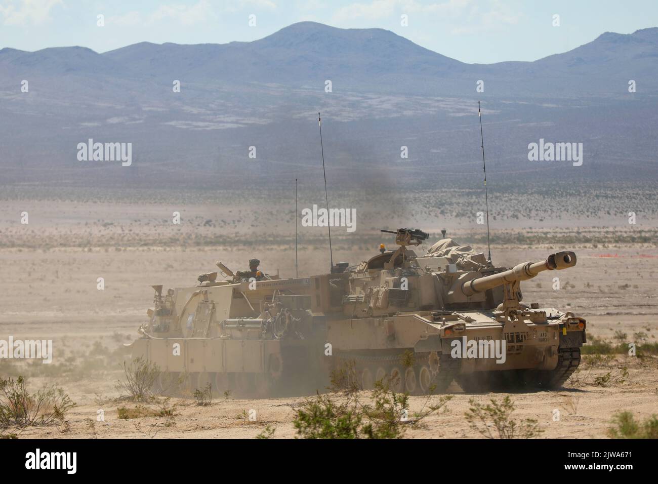 U.S. Soldiers assigned to 2nd Battalion, 70th Armored Regiment, 2nd Armored Brigade Combat Team, 1st Infantry Division transport a M109 Paladin using a M88 Hercules Recovery Vehicle during Decisive Action Rotation 22-09 at the National Training Center, Fort Irwin, Calif., Aug. 14, 2022 (U.S. Army photo by Sgt. Ryan Gosselin, Operations Group, National Training Center) Stock Photo