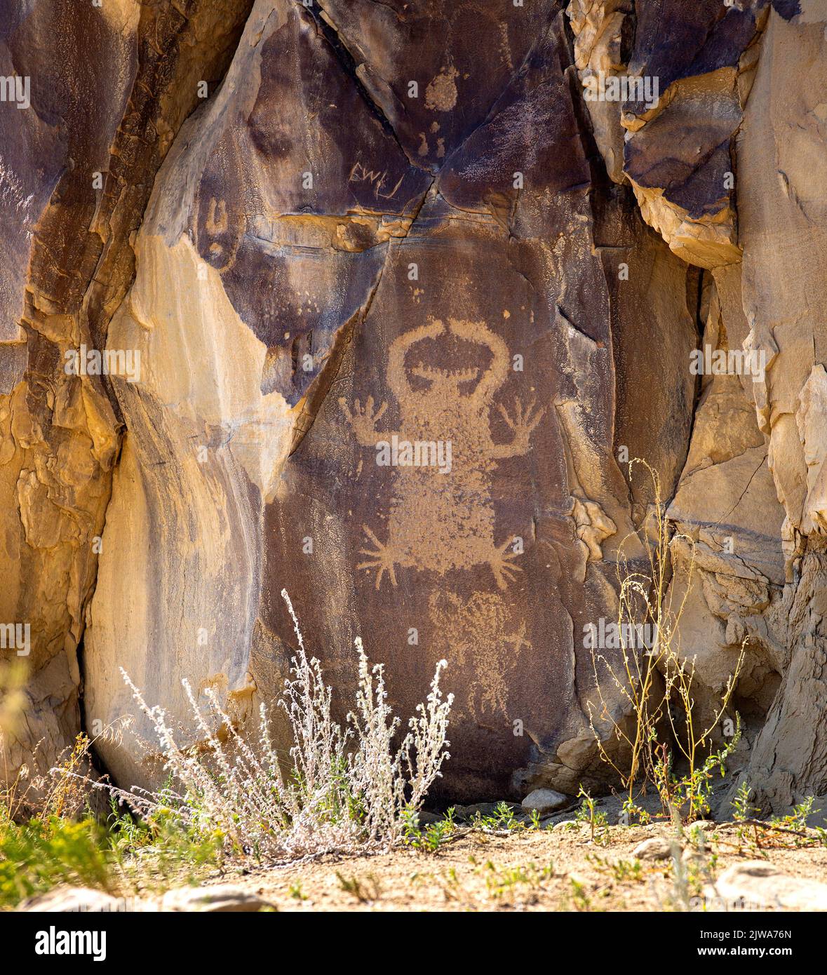 Petroglyphs rock art in Legend Rock State Archaeological Site, Wyoming - Outlined and en toto pecked anthropomorphic form is an example of the Dinwood Stock Photo