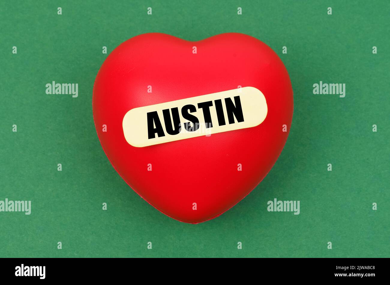 On a green surface lies a red heart with the inscription - Austin Stock Photo