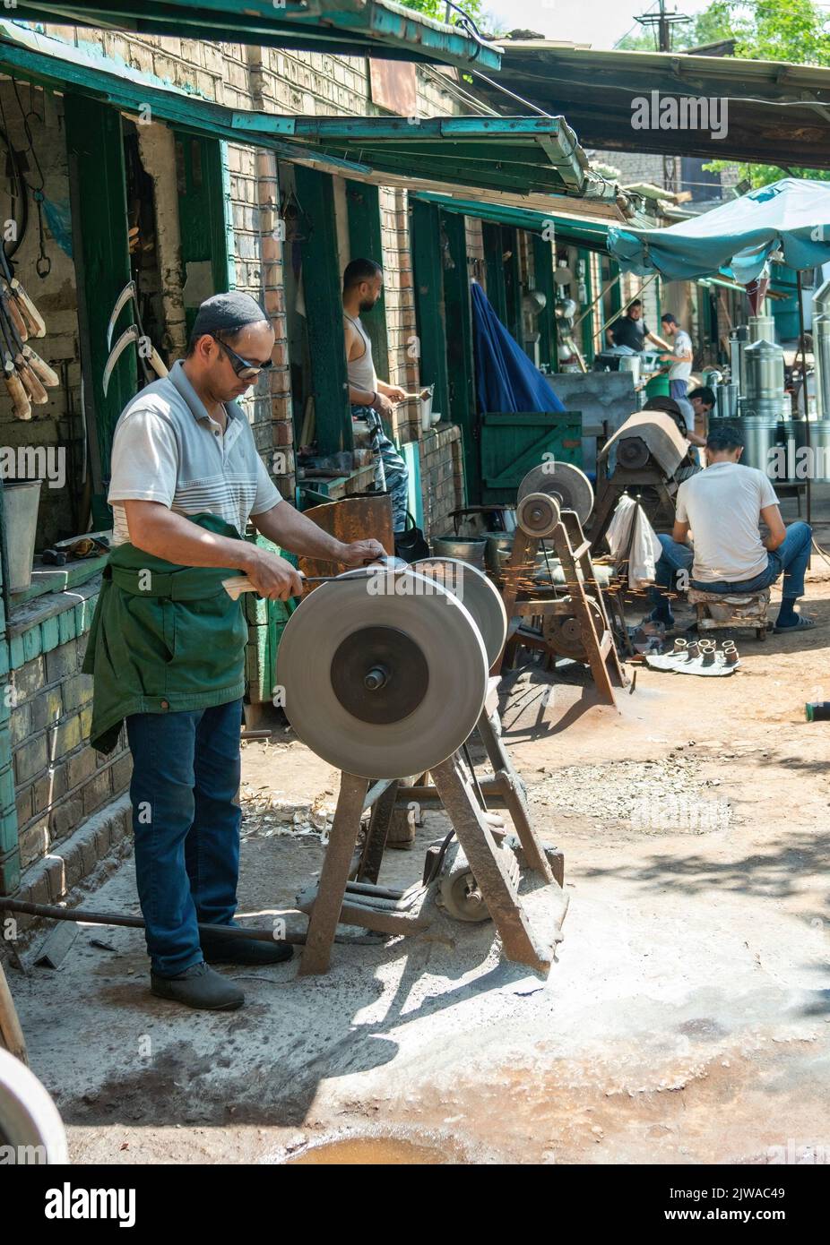 Premium Photo  Knife sharpener and a hand with a blade a man sharpens a  knife on a grinder