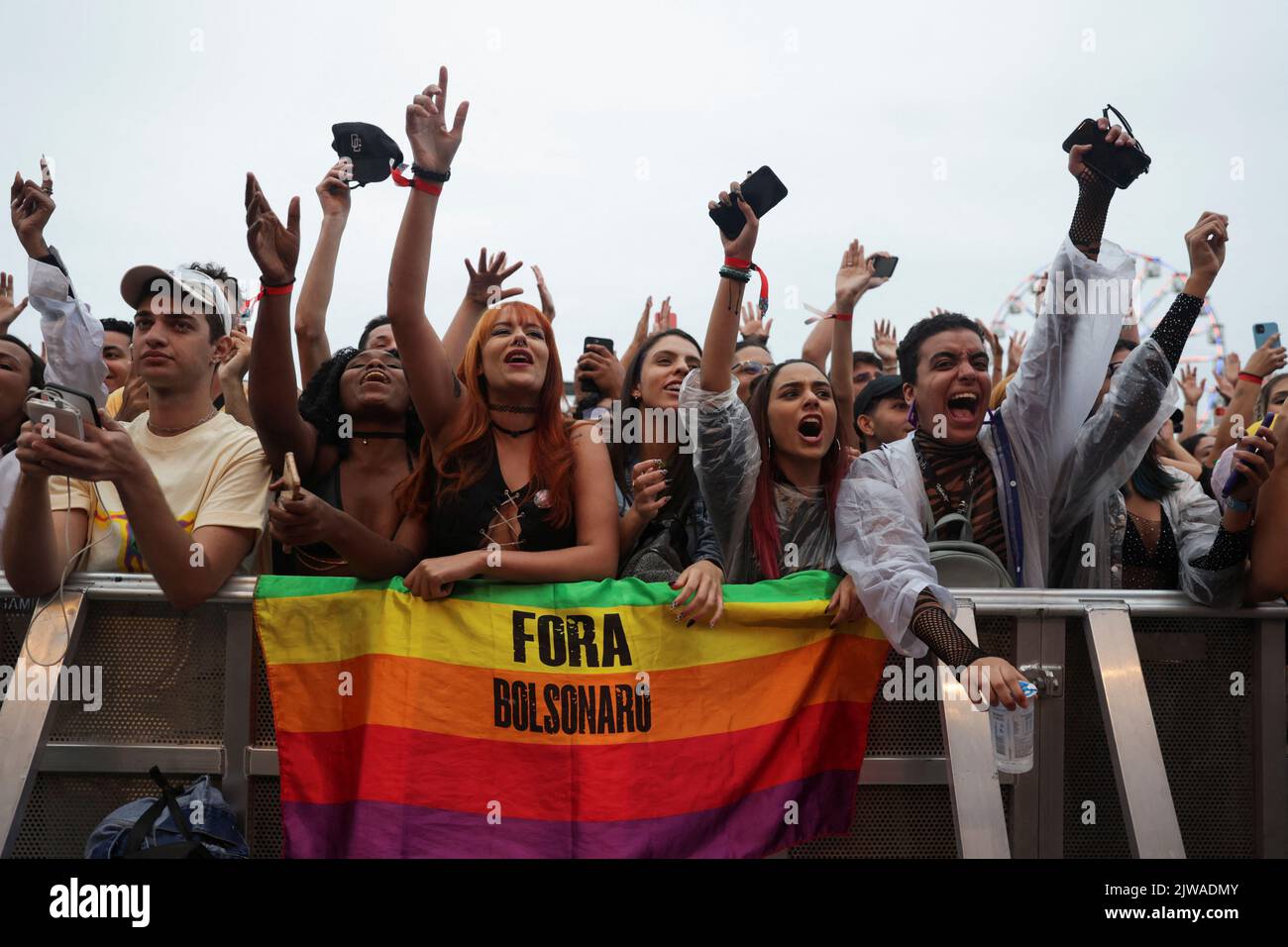 A flag reading 'Out Bolsonaro' is seen as fans attend the Rock in Rio music festival in Rio de Janeiro, Brazil September 4, 2022. REUTERS/Pilar Olivares Stock Photo