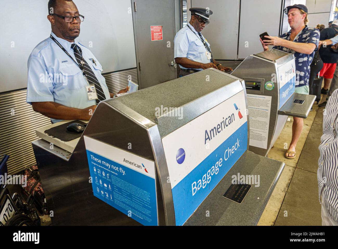 Miami Florida,Miami International Airport MIA terminal,American Airlines Black skycap curbside baggage check,man men male woman women female,US USA Un Stock Photo
