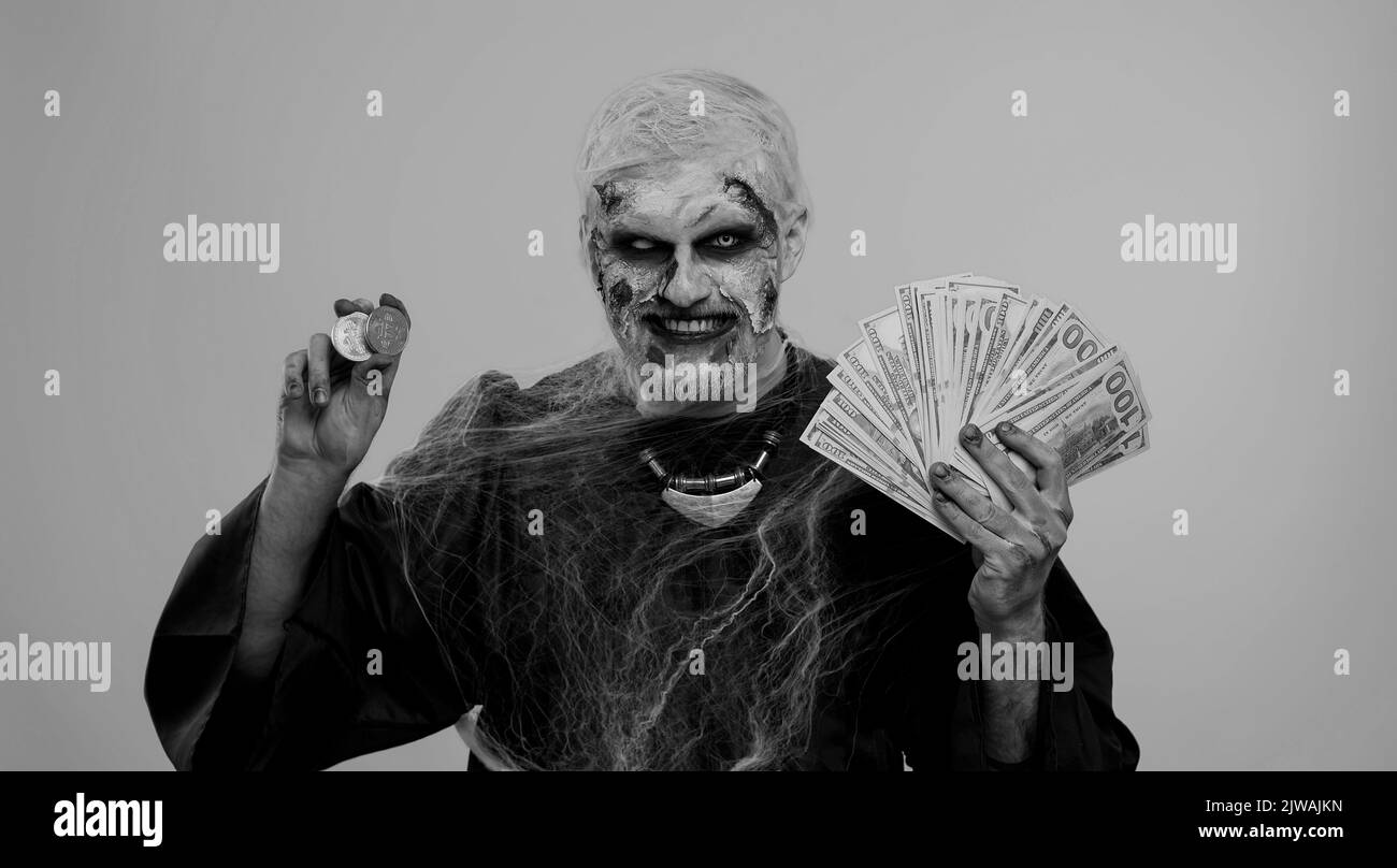Creepy smiling man with bloody scars face, Halloween zombie showing golden  bitcoins with money dollar cash banknotes. Achievement career wealth,  cryptocurrency investment, mining, future technology Stock Photo - Alamy