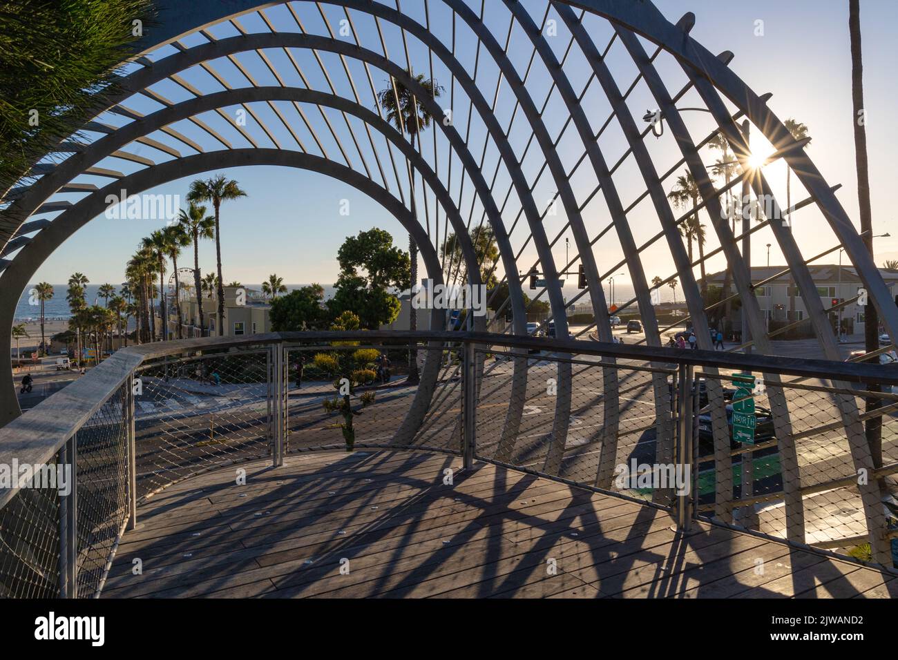Lens flare through artwork in Santa Monica with the pier in the distance Stock Photo