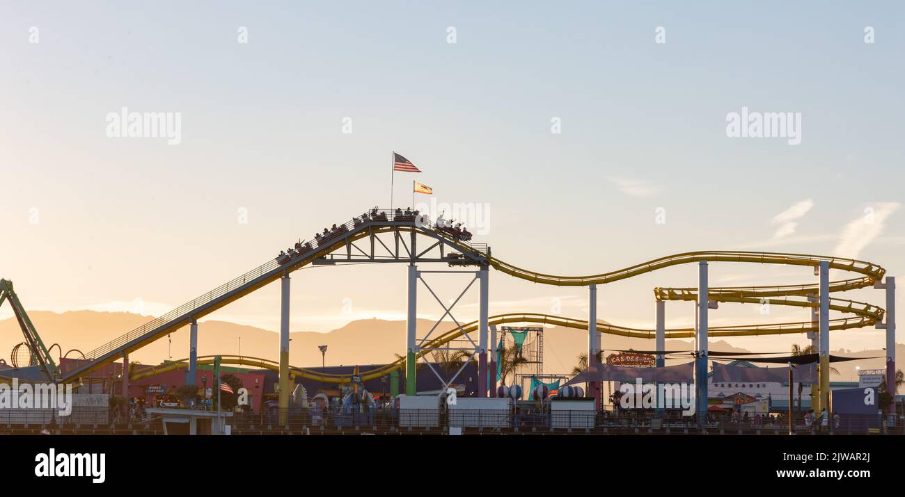 Roller coaster on Santa Monica pier at sunset Stock Photo