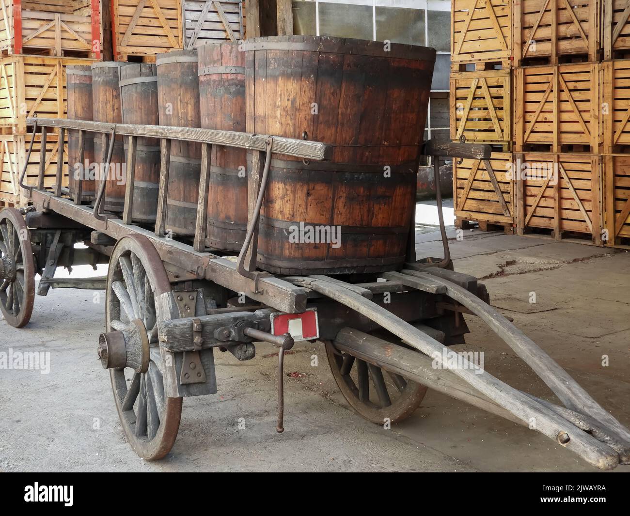 old wooden cart with wooden crates to hold wine bottles in the background Stock Photo