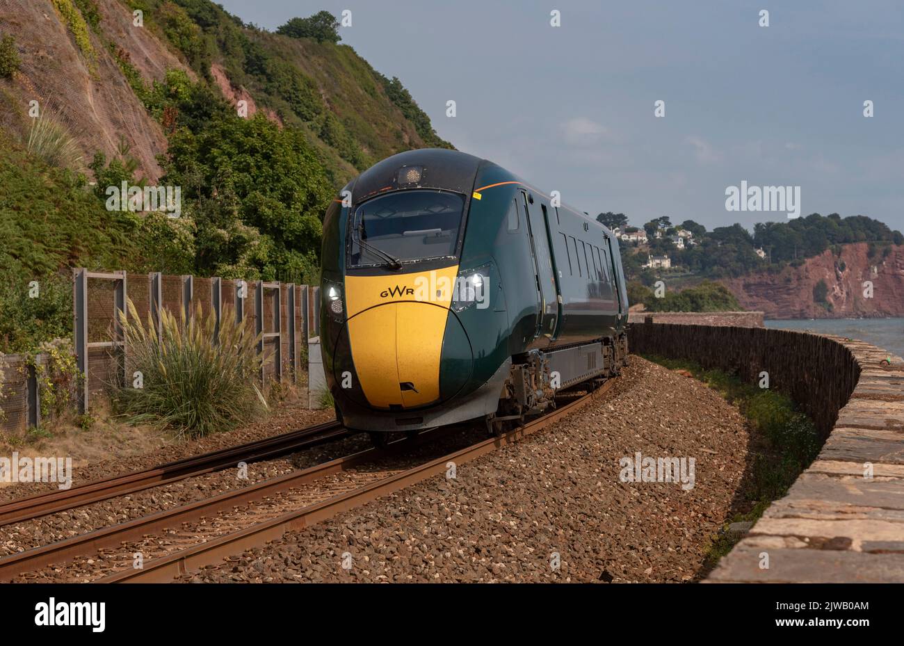 Teignmouth, Devon, England, UK. 2022. Passenger train  approaching Teignmouth, from Dawlish, Devon along the south west coast line. Stock Photo