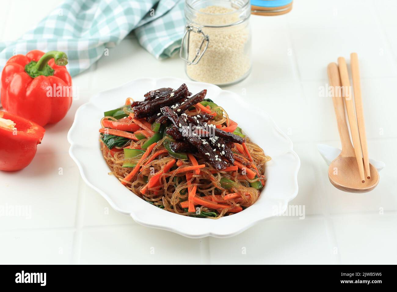 Japchae or Chap Chae, Korean Glass Noodle Dish with Beef Bulgogi and Sesame Seed Topping Stock