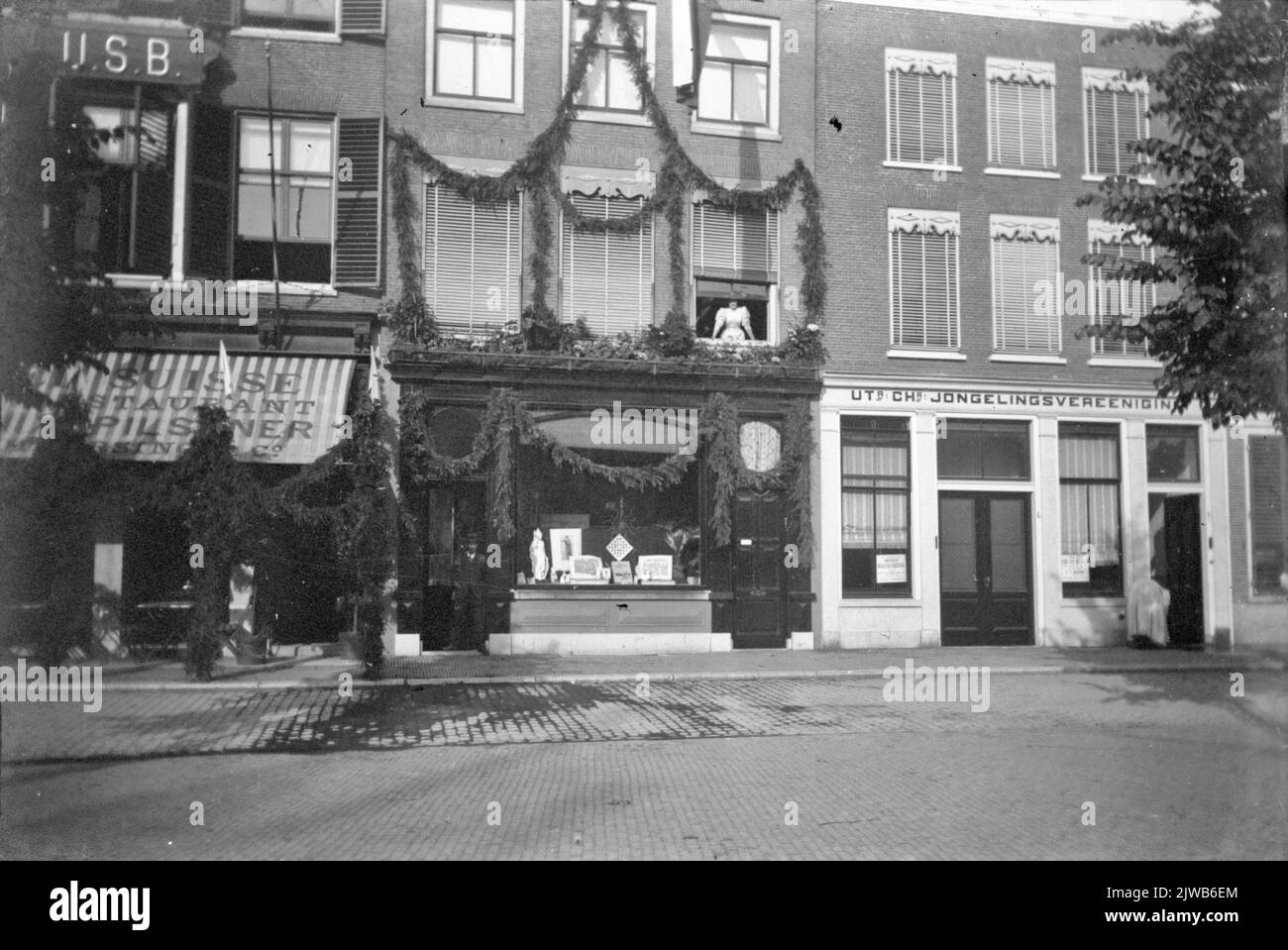 View of the decorated facade of the building of Steenprintkerij Joh. A. Moesman (Neude 7) in Utrecht, on the occasion of a student party (presumably lustrum). On the right the facade of the Neude 6 building (Utr. Chr. Youth Association). Stock Photo