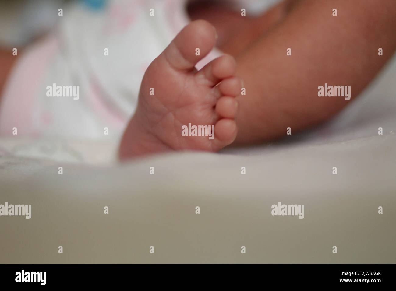 Newborn foot. Closeup of cute new born feet Stock Photo - Alamy