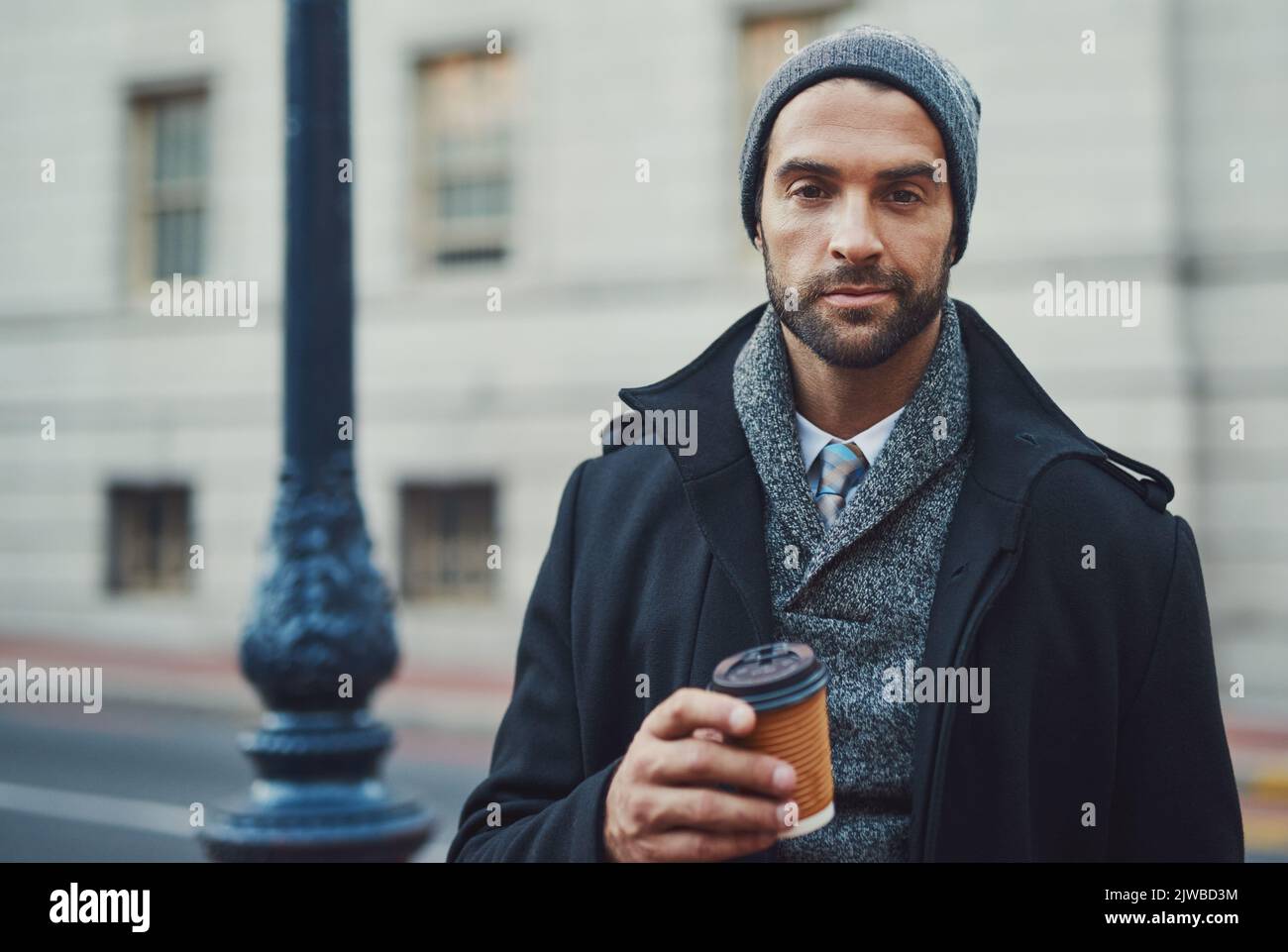 Coffee is my fuel. a fashionable young man in an urban setting. Stock Photo