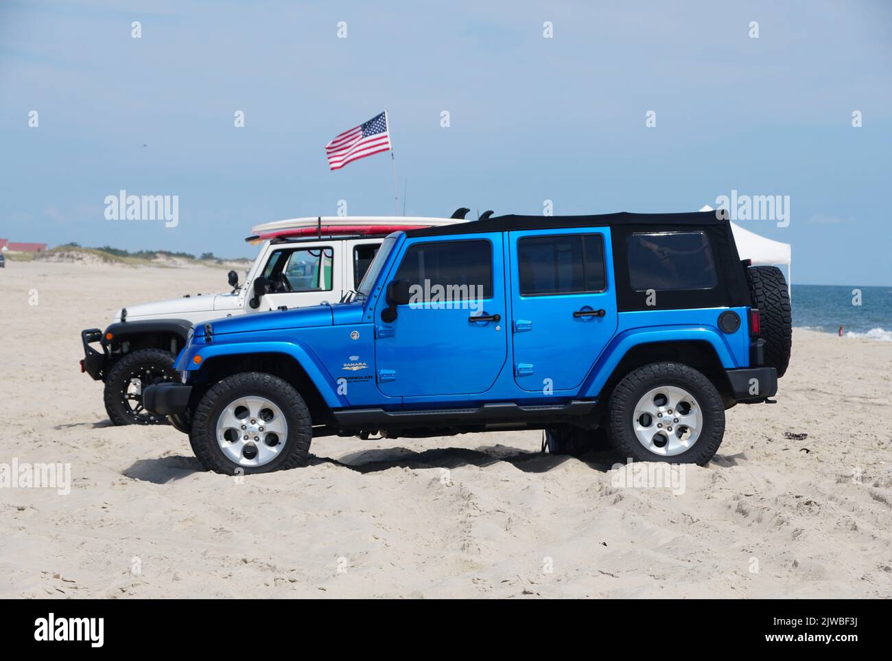 Dewey Beach, Delaware, U.S.A - September 3, 2022 - A bright blue Jeep Wrangler parked on the beach Stock Photo