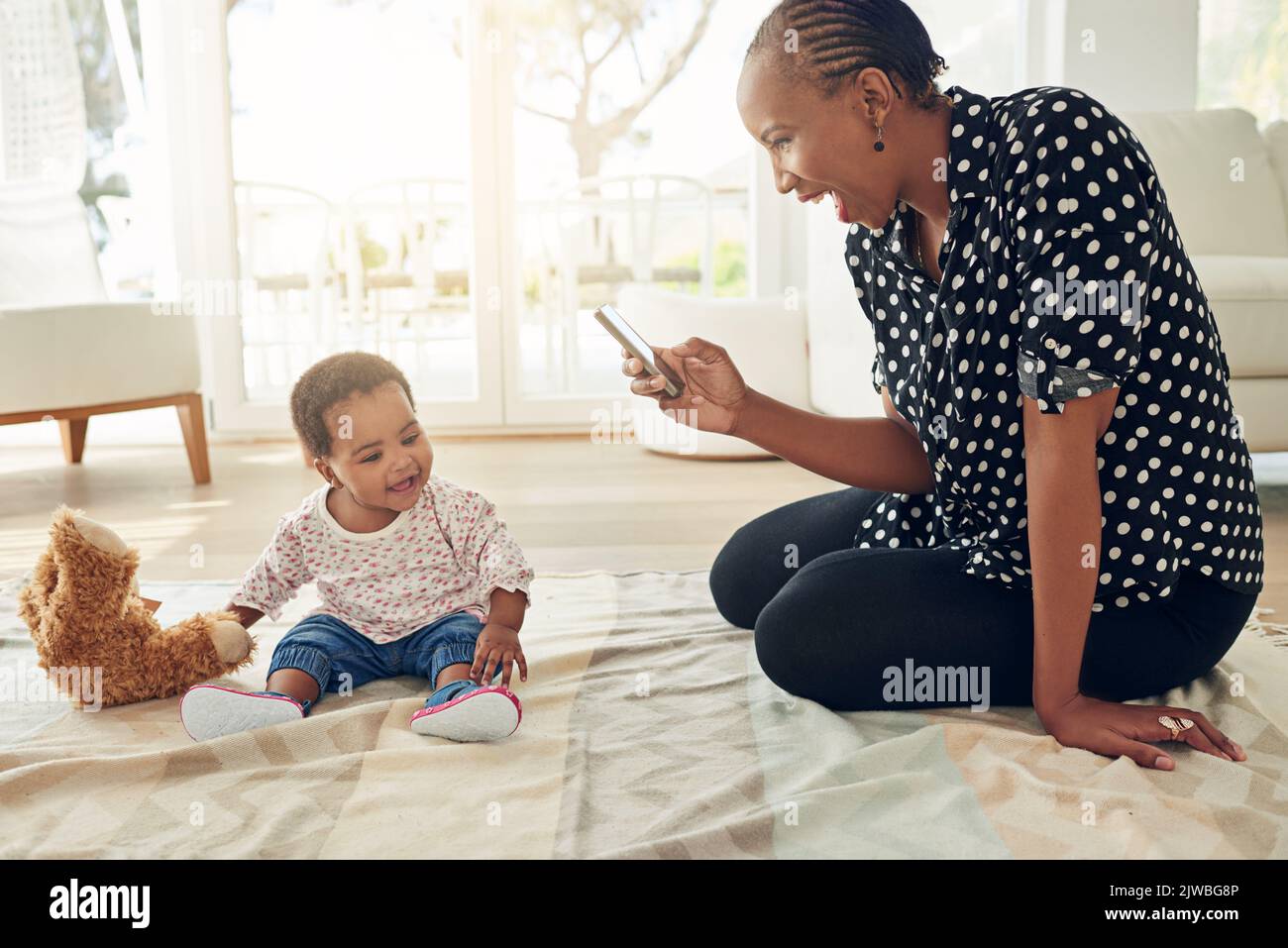 Fun times all around. a mother taking a photo of her baby girl. Stock Photo