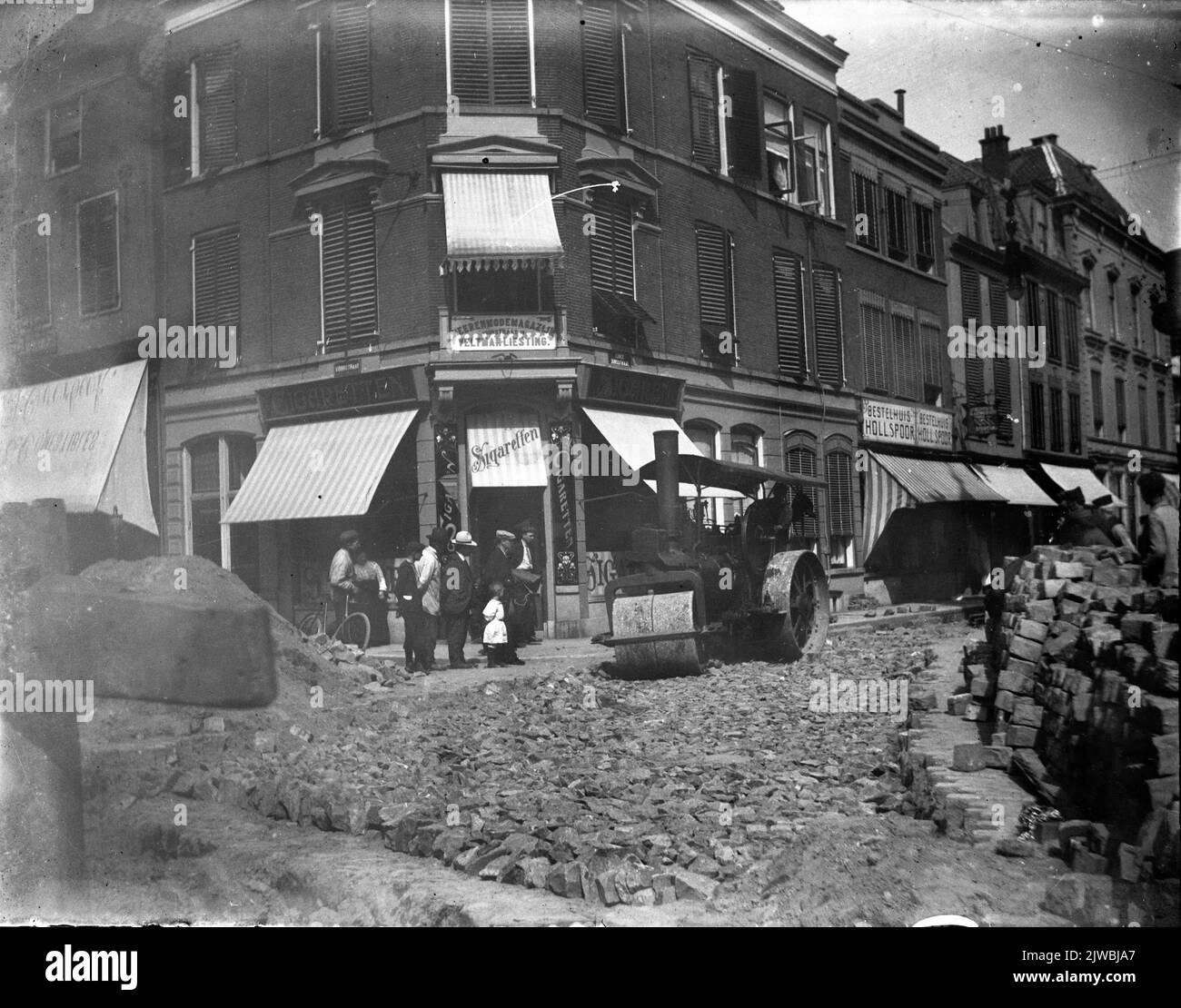 View in the Lange Jansstraat in Utrecht during paving work with the entrance to the Voorstraat on the left with the Voorstraat 1 corner house in the middle. Stock Photo