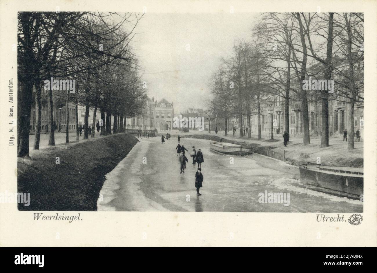 View of the frozen Stadsbuitengracht in Utrecht with some skaters; On the right a few houses on the Weerdsingel O.Z Stock Photo
