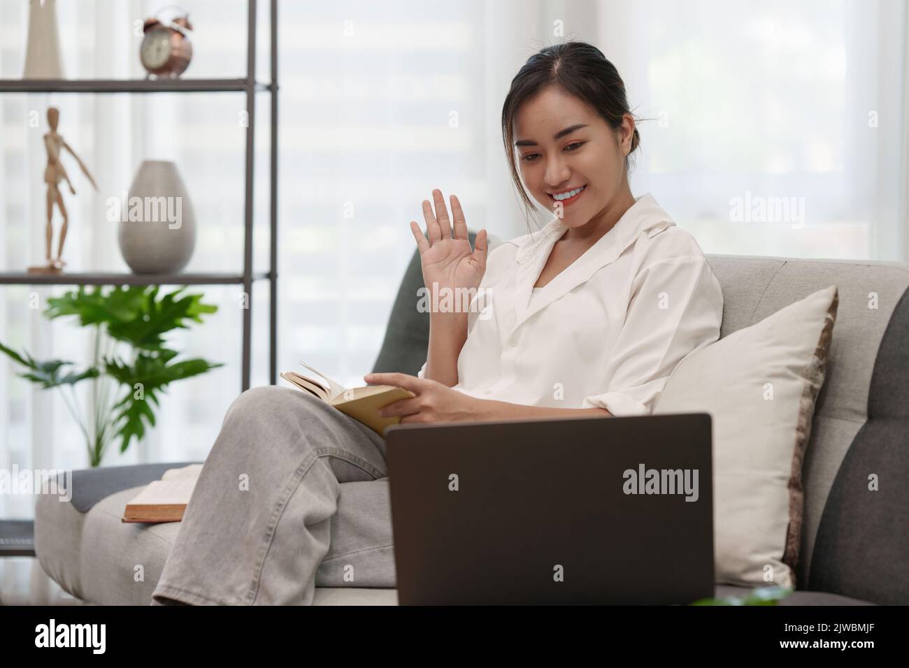 Asian woman have video call meeting with partner by laptop computer ...