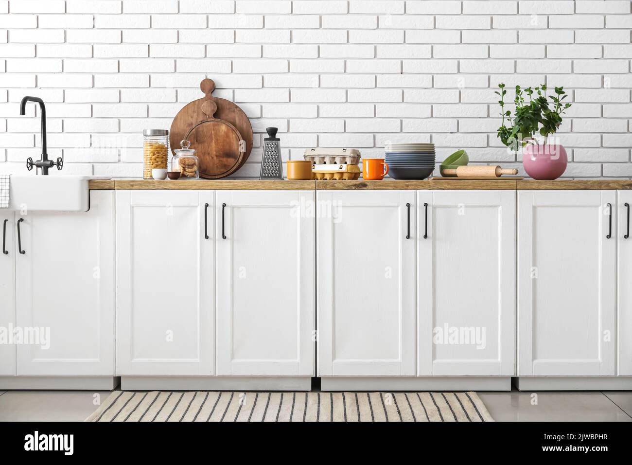 Interior of light kitchen with white counters and food Stock Photo - Alamy