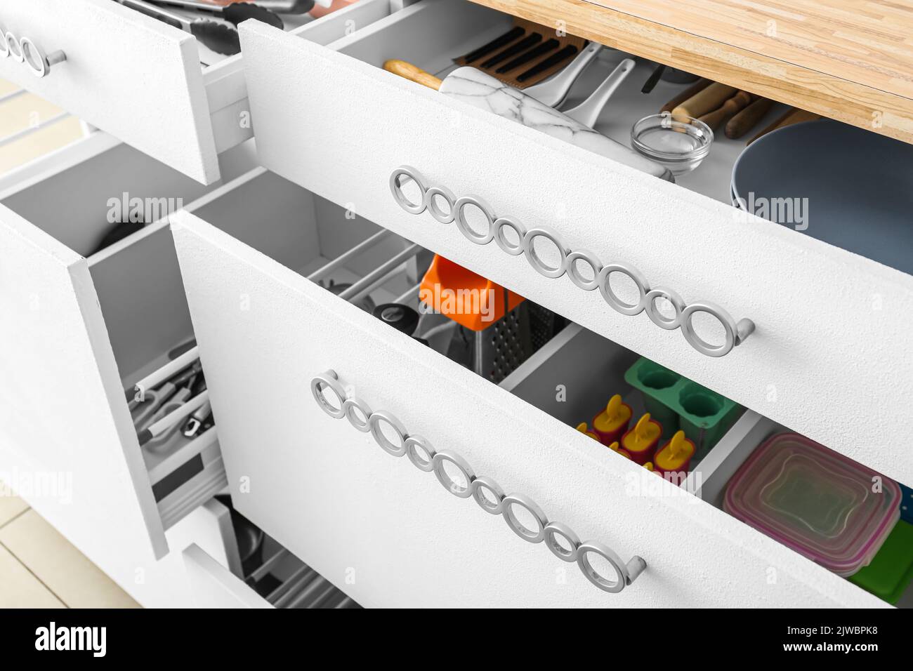 Open drawers with utensils in kitchen, closeup Stock Photo Alamy