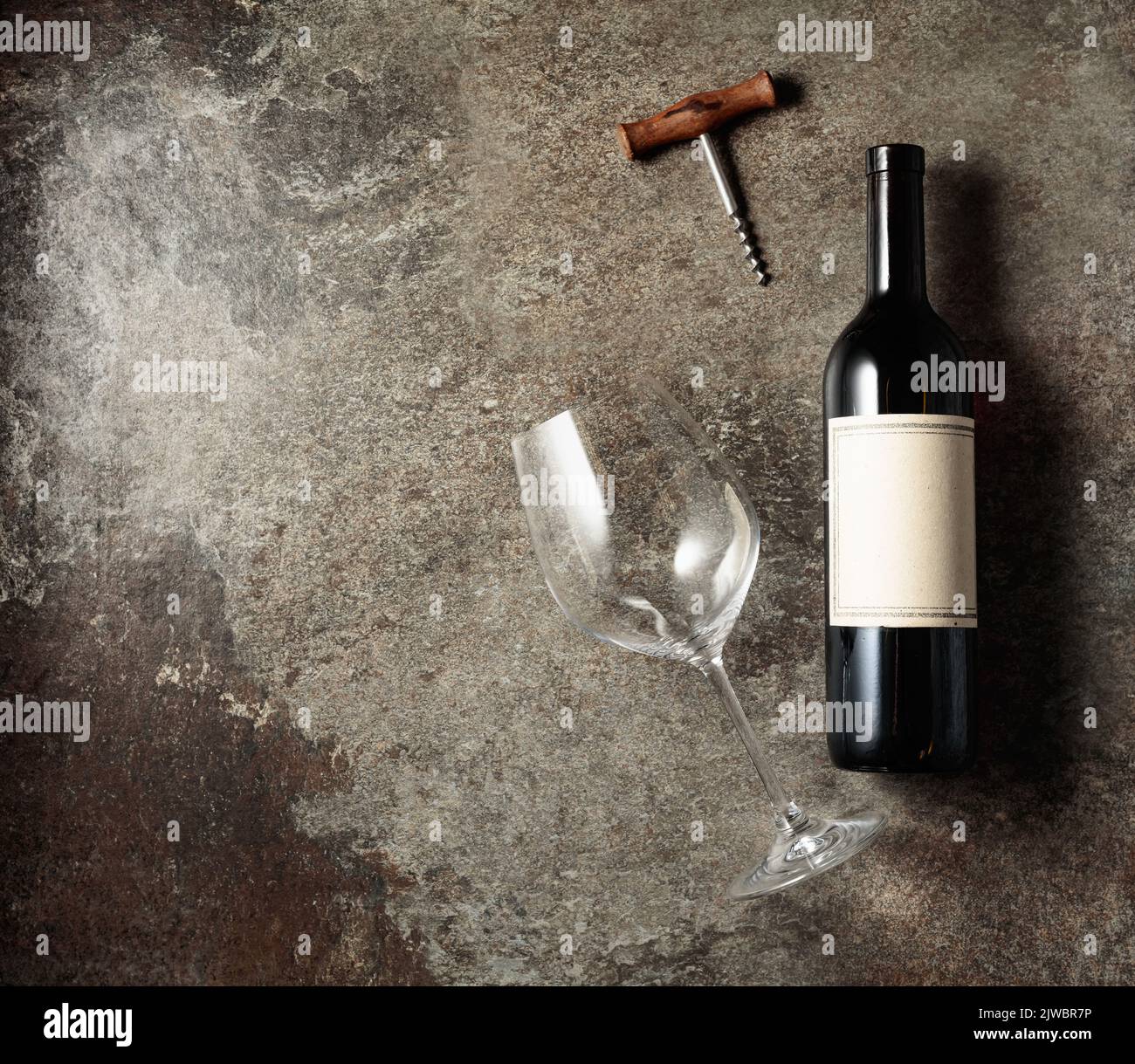 Red wine on an old rough background. Bottle with an old empty label