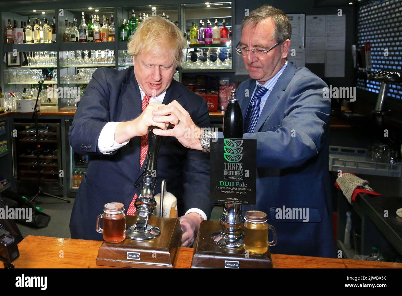 File photo dated 14/12/19 of Prime Minister Boris Johnson (left) pulling a pint with newly elected Conservative party MP for Sedgefield, Paul Howell during a visit to Sedgefield Cricket Club in County Durham. Either Liz Truss or Rishi Sunak will be declared as the new leader of the Conservative Party, and successor to Prime Minister Boris Johnson, on Monday afternoon. The incoming PM will face a daunting set of challenges including an energy crisis, soaring inflation, further strike action and the ongoing war in Ukraine.Issue date: Monday September 5, 2022. Stock Photo