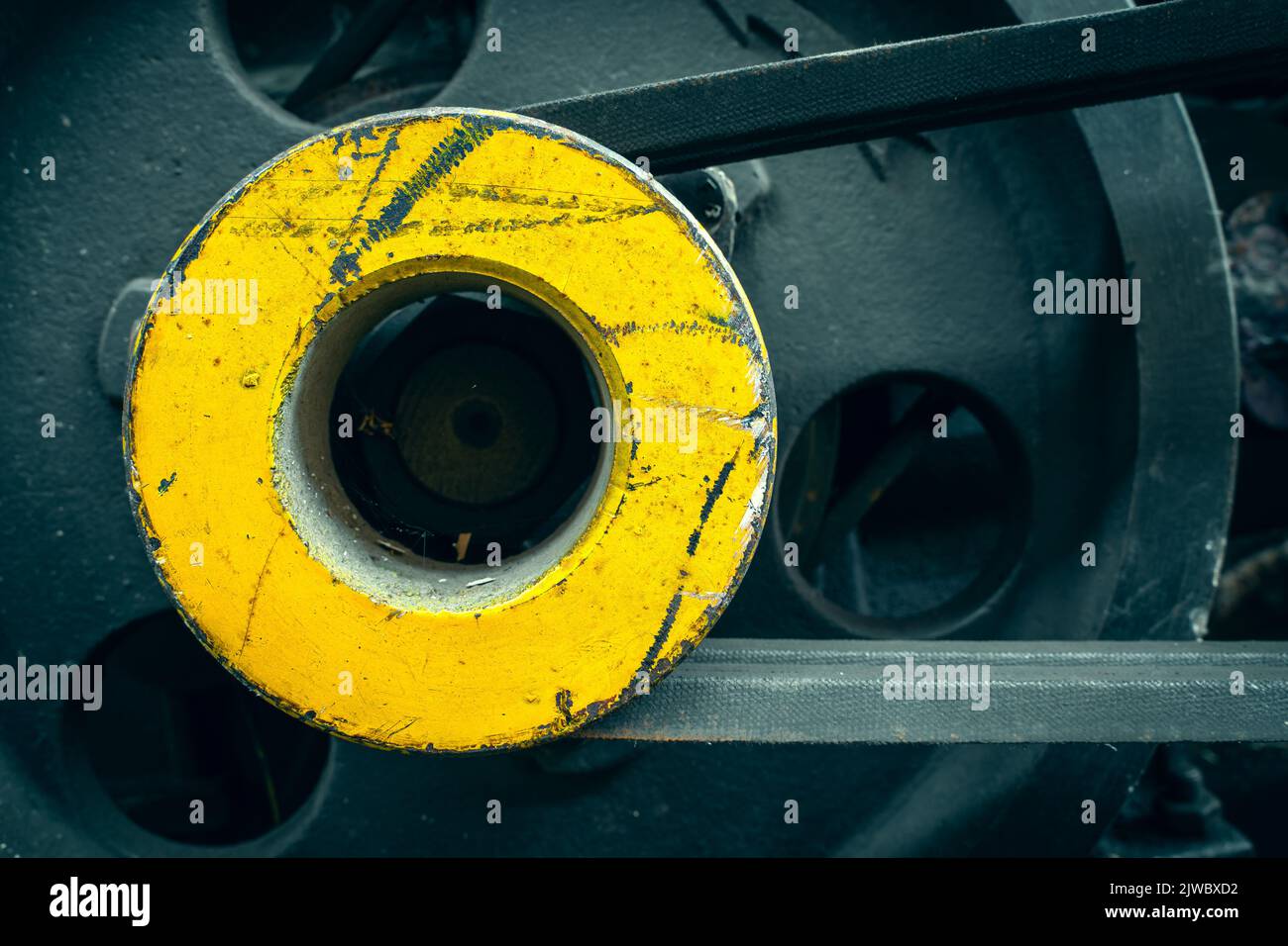 Round yellow motoblock pulley with drive belts close-up. Background from an industrial object. Agricultural machinery Stock Photo
