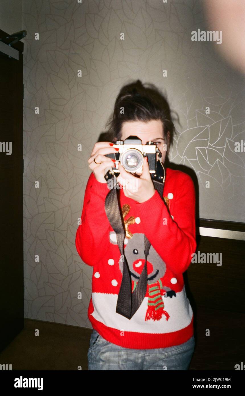 Vertical indoor analog photo of an unrecognizable middleaged caucasian