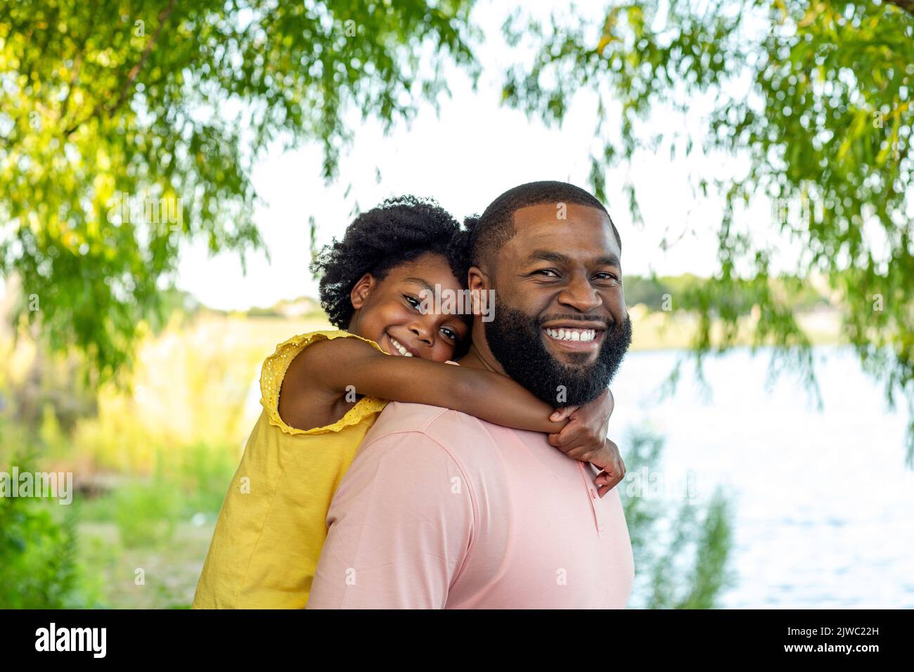 Father and daughter smiling and laughing outside. Stock Photo