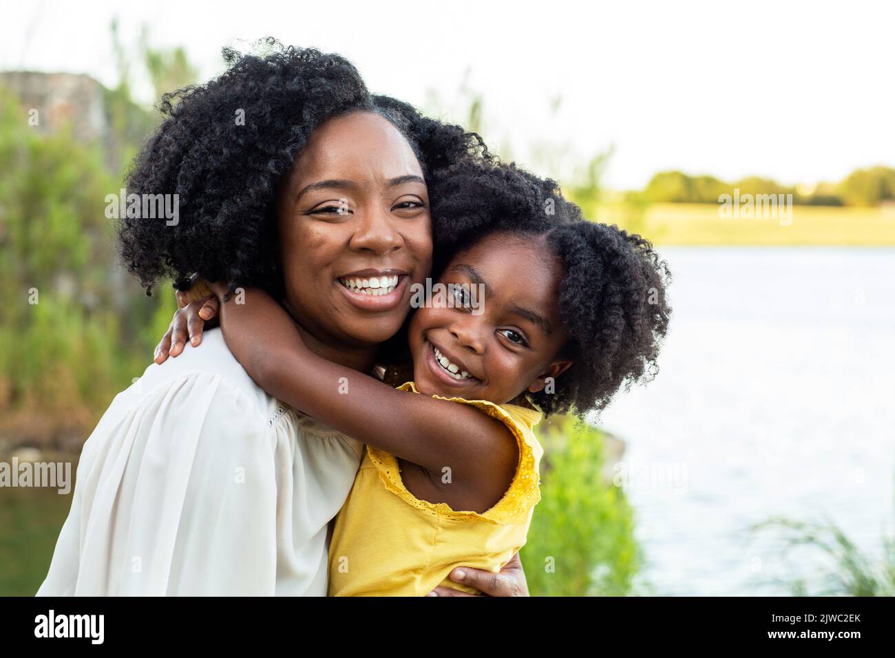 Happy mother and her beautiful daughter smiling. Stock Photo