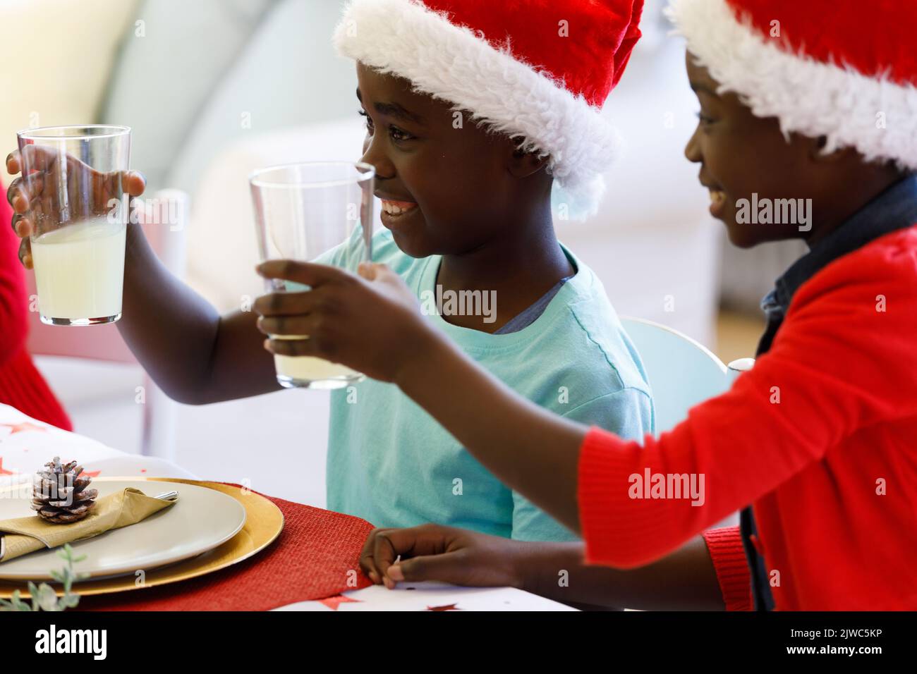 African american boy and girl holding glasses of juice Stock Photo - Alamy