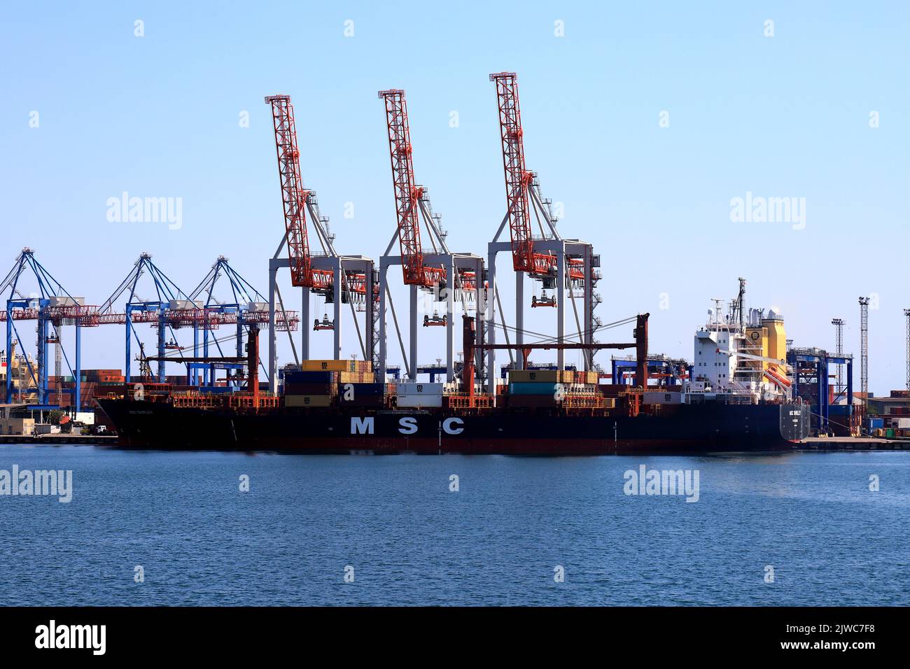 Seaport Odessa, Ukraine, 2022-07-30. Export of grain from Ukraine. Cranes load ships, containers in seaport of Odesa. Grain agreement, delivery of goo Stock Photo