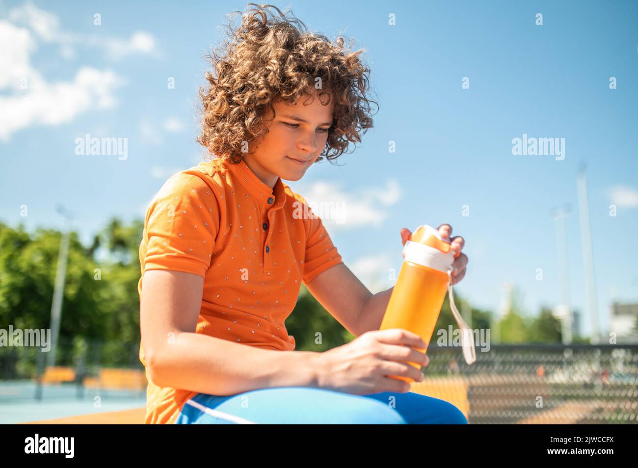Teenage kid preparing to drink water outdoors Stock Photo - Alamy